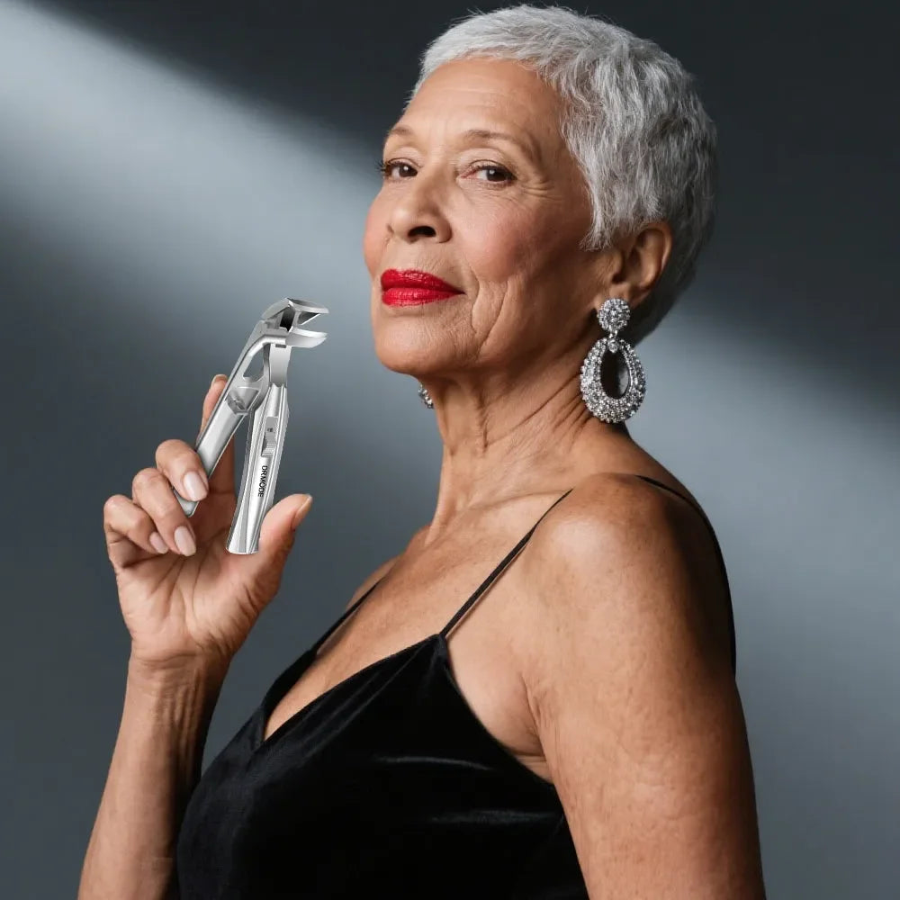 Elegant older woman in black dress holding stainless steel nail clippers, jewelry visible