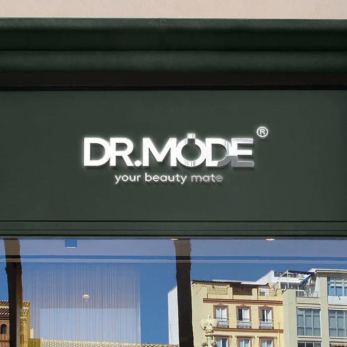 Modern shop exterior with illuminated sign reading 'DR.MODE your beauty mate' above windows