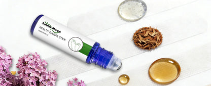 Toenail treatment stick with liquid, wooden shavings, and lilac flowers on white background.