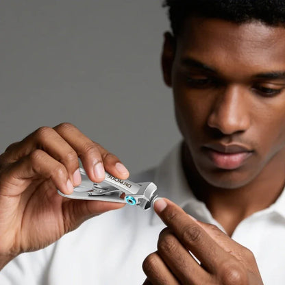 Man using stainless steel nail clippers for precise grooming on fingernails.